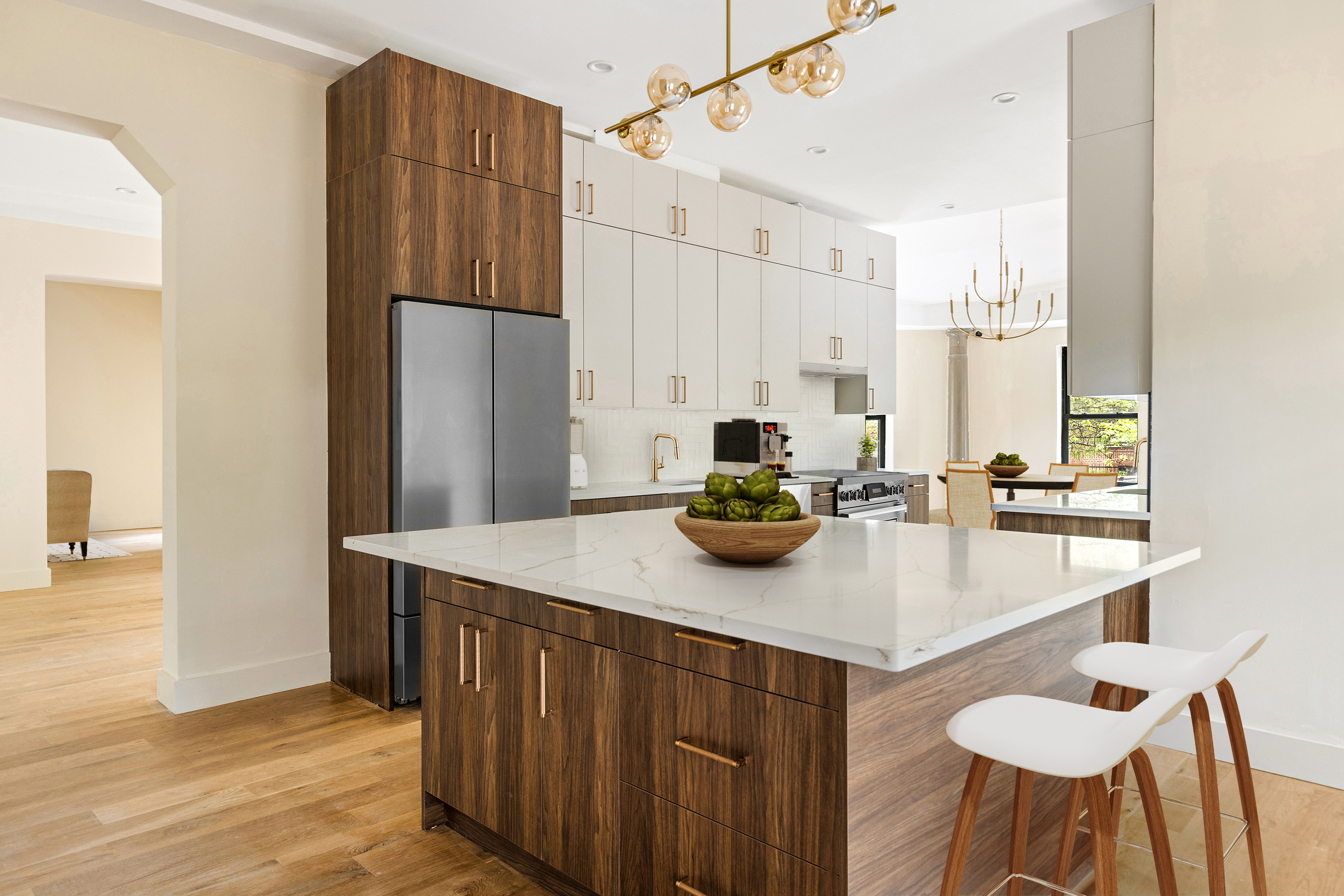 697 East 21st Street Brooklyn, NY 11210 - Photo 3 of 24 a kitchen with kitchen island a sink table and chairs
