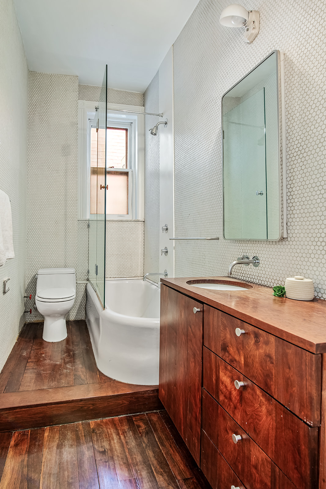 39 1/2 Washington Square South, Unit 9 Manhattan, NY 10012 - Photo 10 of 12 a bathroom with a sink and a mirror