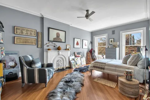 a living room with furniture a wooden floor and a window