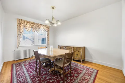 a view of a dining room with furniture wooden floor and a chandelier