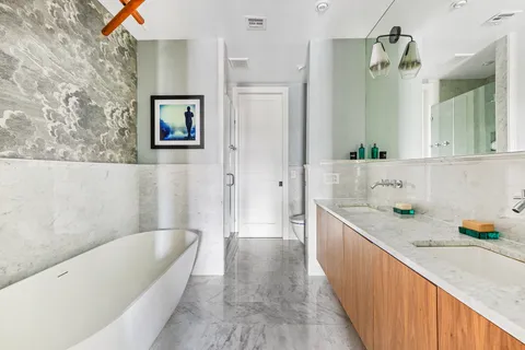 a bathroom with a bathtub a sink and a window