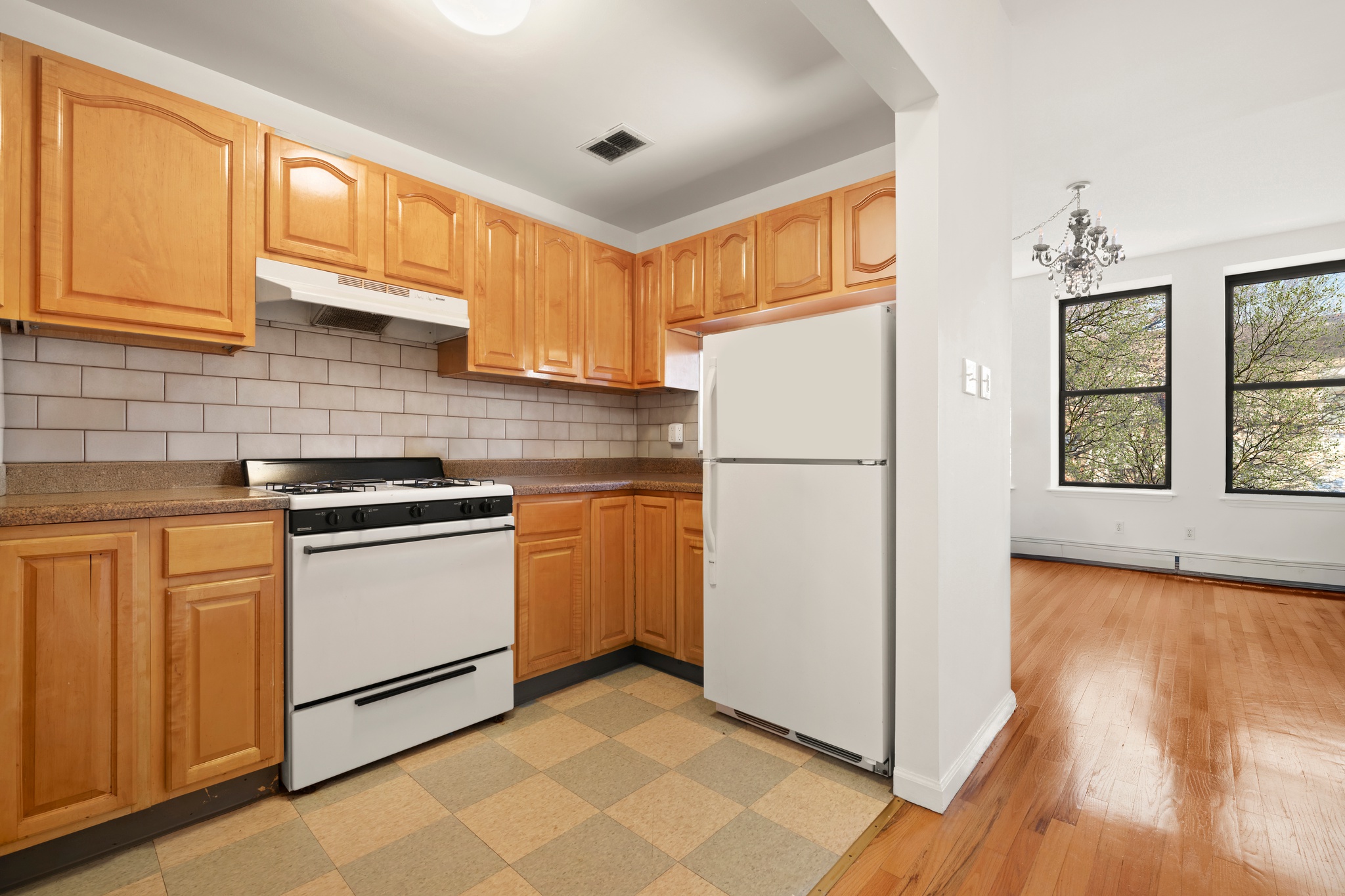 522 West 149th Street, Unit 3 Manhattan, NY 10031 - Photo 4 of 7 a kitchen with a refrigerator sink stove and cabinets