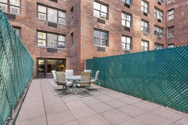 a view of a patio with a table and chairs