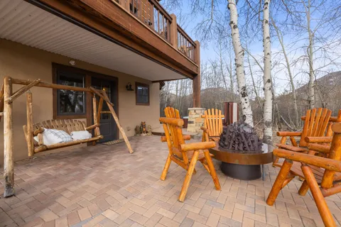a view of patio with a table and chairs and potted plants