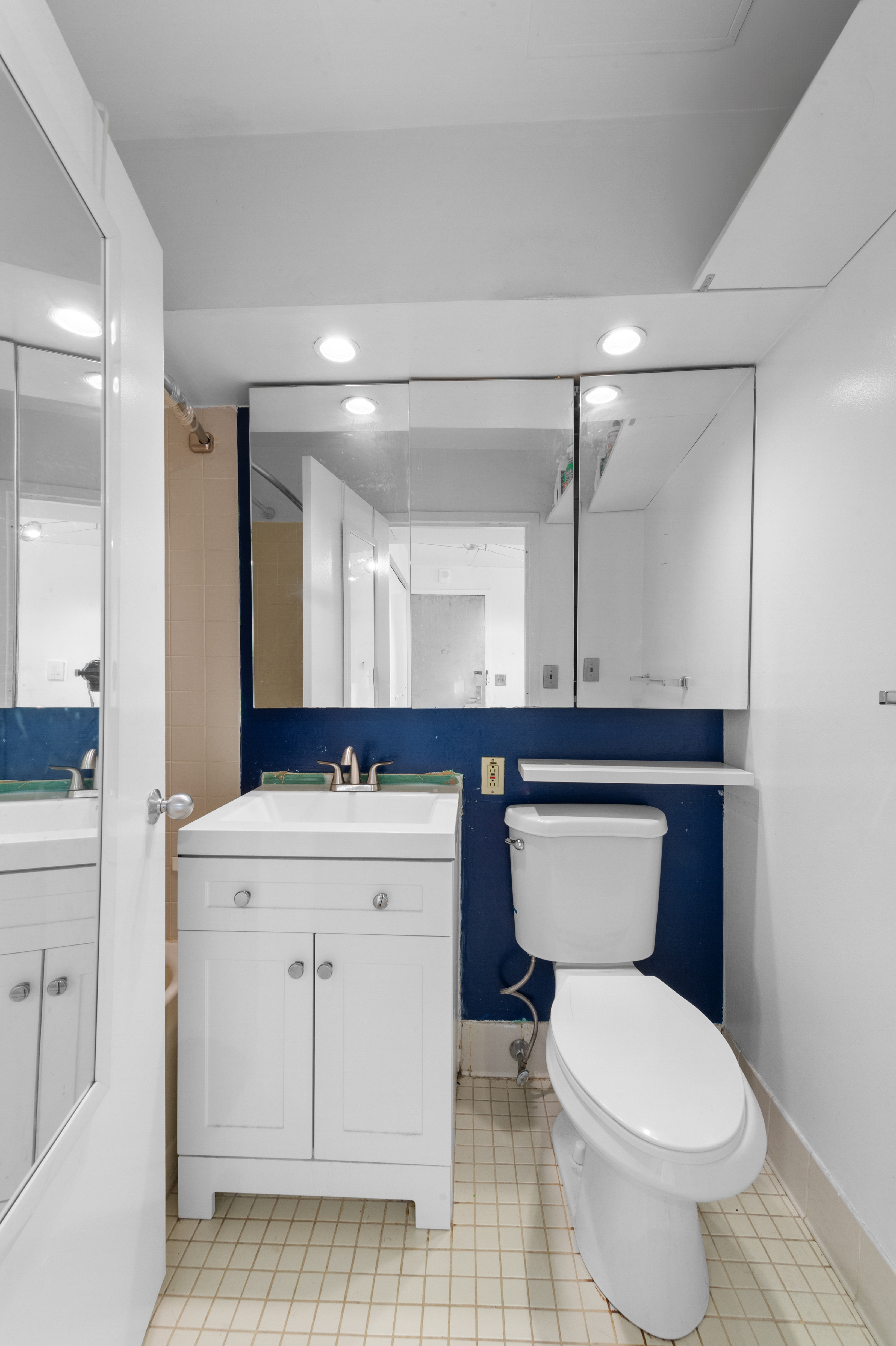 376 Broadway, Unit 24G Manhattan, NY 10013 - Photo 6 of 8 a bathroom with a toilet sink and mirror