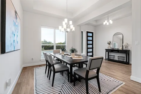 a view of a dining room with furniture and chandelier