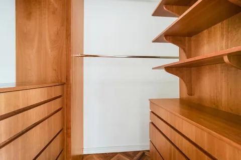 a view of storage and utility room with wooden floor