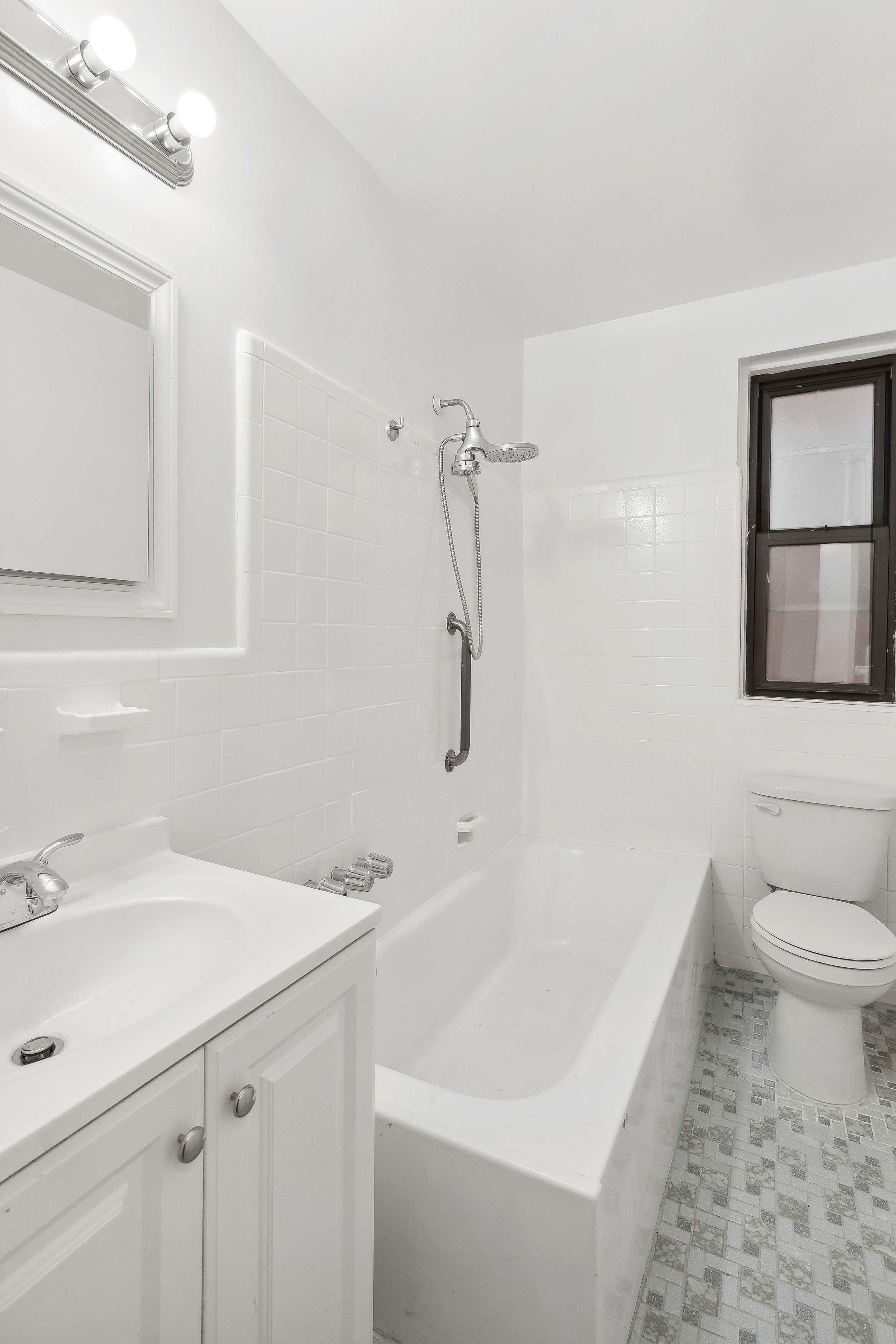 445 West 240th Street, Unit 3A Bronx, NY 10463 - Photo 5 of 8 a bathroom with a sink a toilet and shower