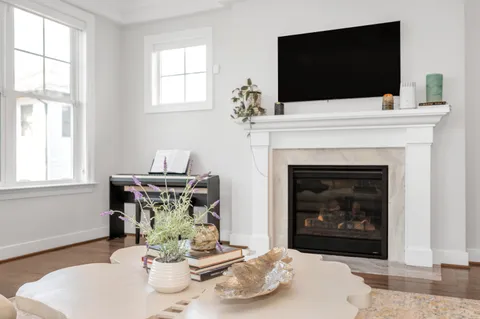 a large kitchen with stainless steel appliances granite countertop lots of counter top space and wooden floor