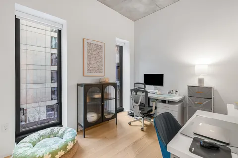 a view of a livingroom with workspace and a couch