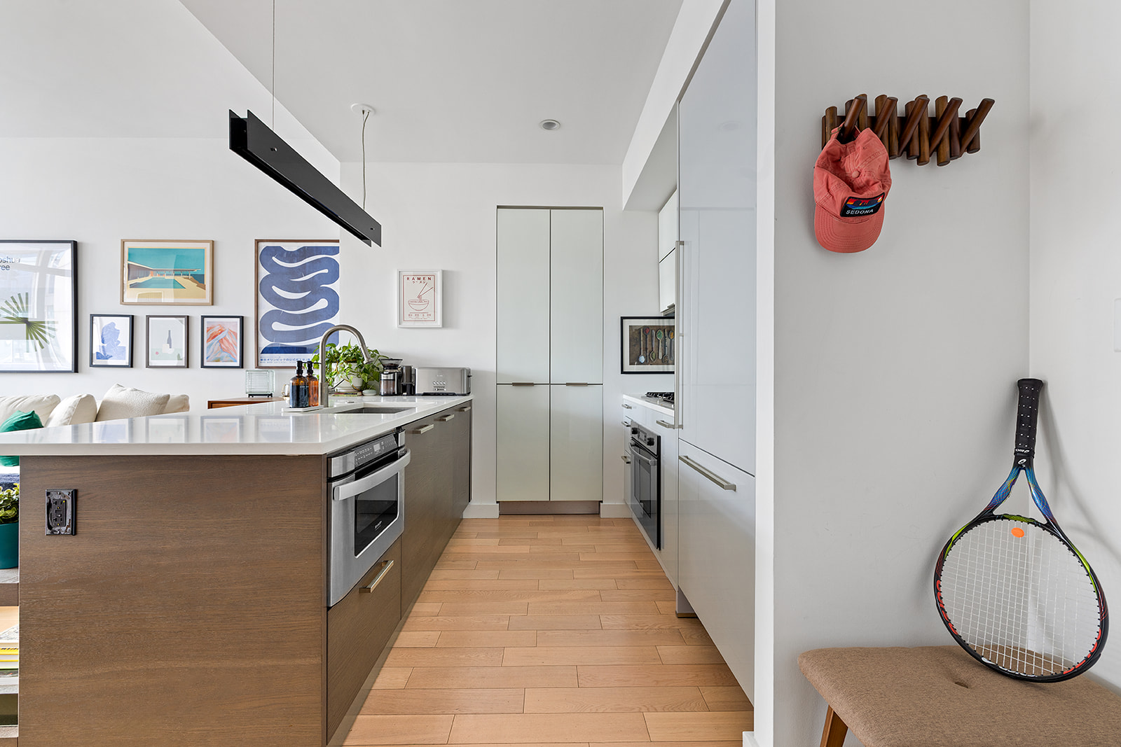 22 North 6th Street, Unit PH2A Brooklyn, NY 11249 - Photo 6 of 12 a kitchen with stainless steel appliances granite countertop a sink and dishwasher a stove top oven with wooden floor