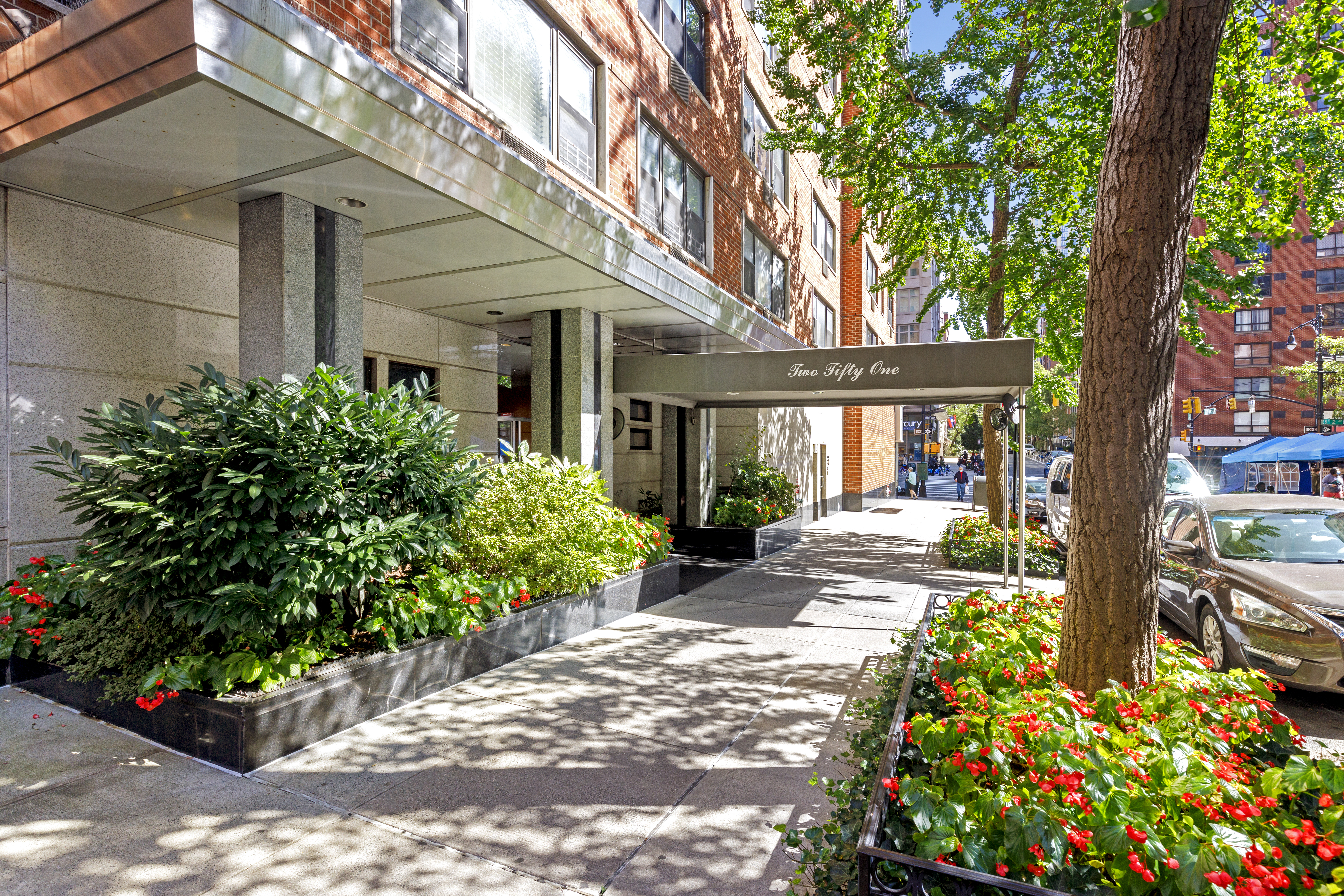 251 East 51st Street, Unit 8D Manhattan, NY 10022 - Photo 1 of 1 a front view of a house with garden