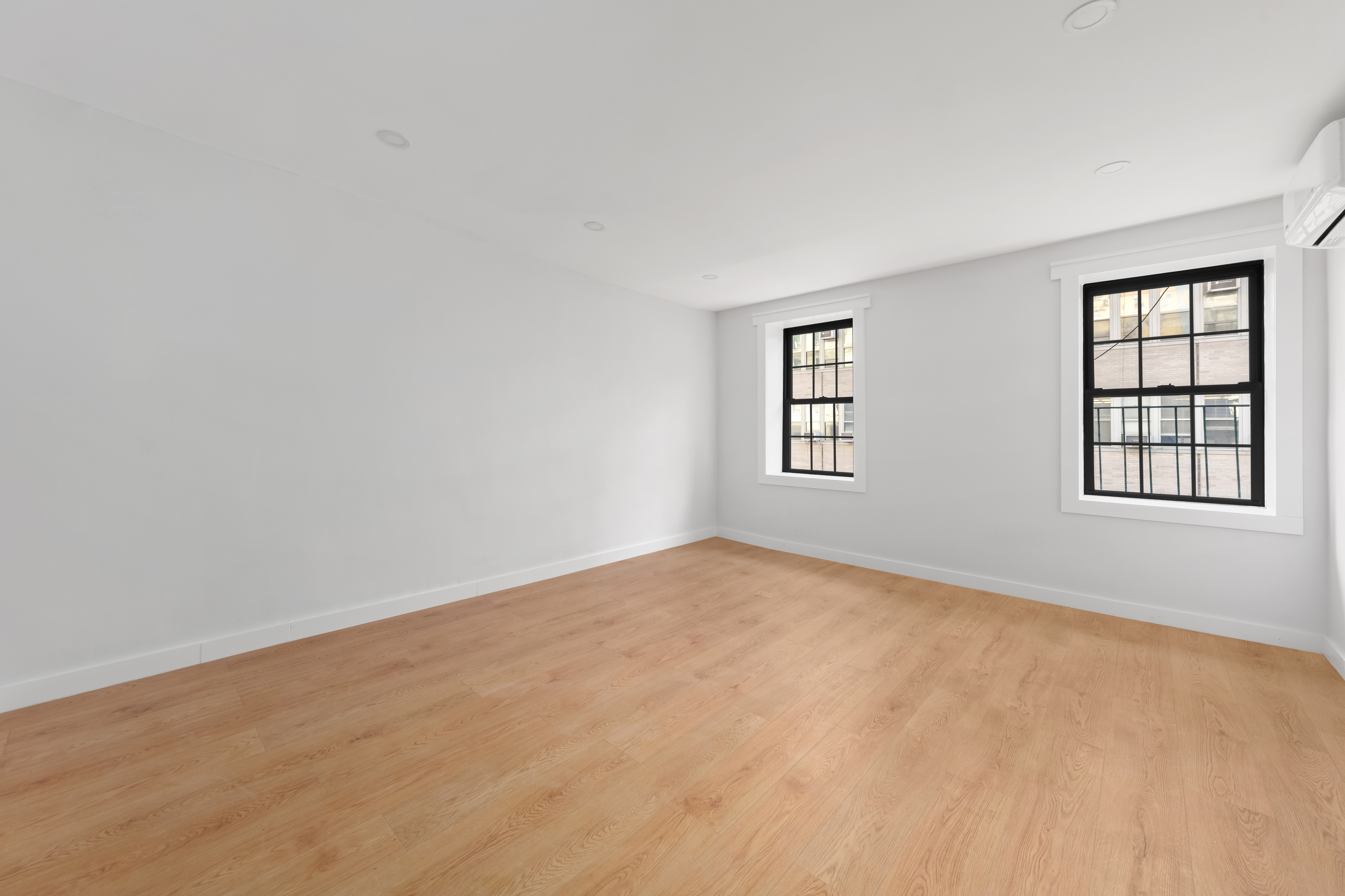 227 East 21st Street, Unit 4F Manhattan, NY 10010 - Photo 3 of 6 an empty room with windows