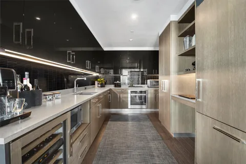 a kitchen with stainless steel appliances a refrigerator a sink and a stove