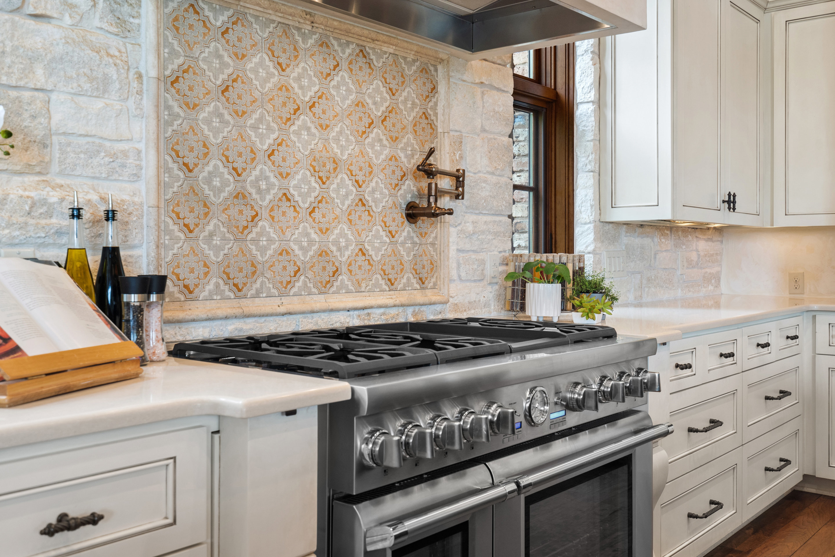 808 Rivercliff Drive Spicewood, TX 78669 - Photo 16 of 71 a kitchen with granite countertop a stove and a white cabinet