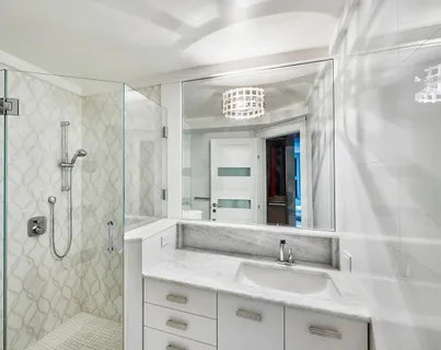 a bathroom with a shower sink and mirror