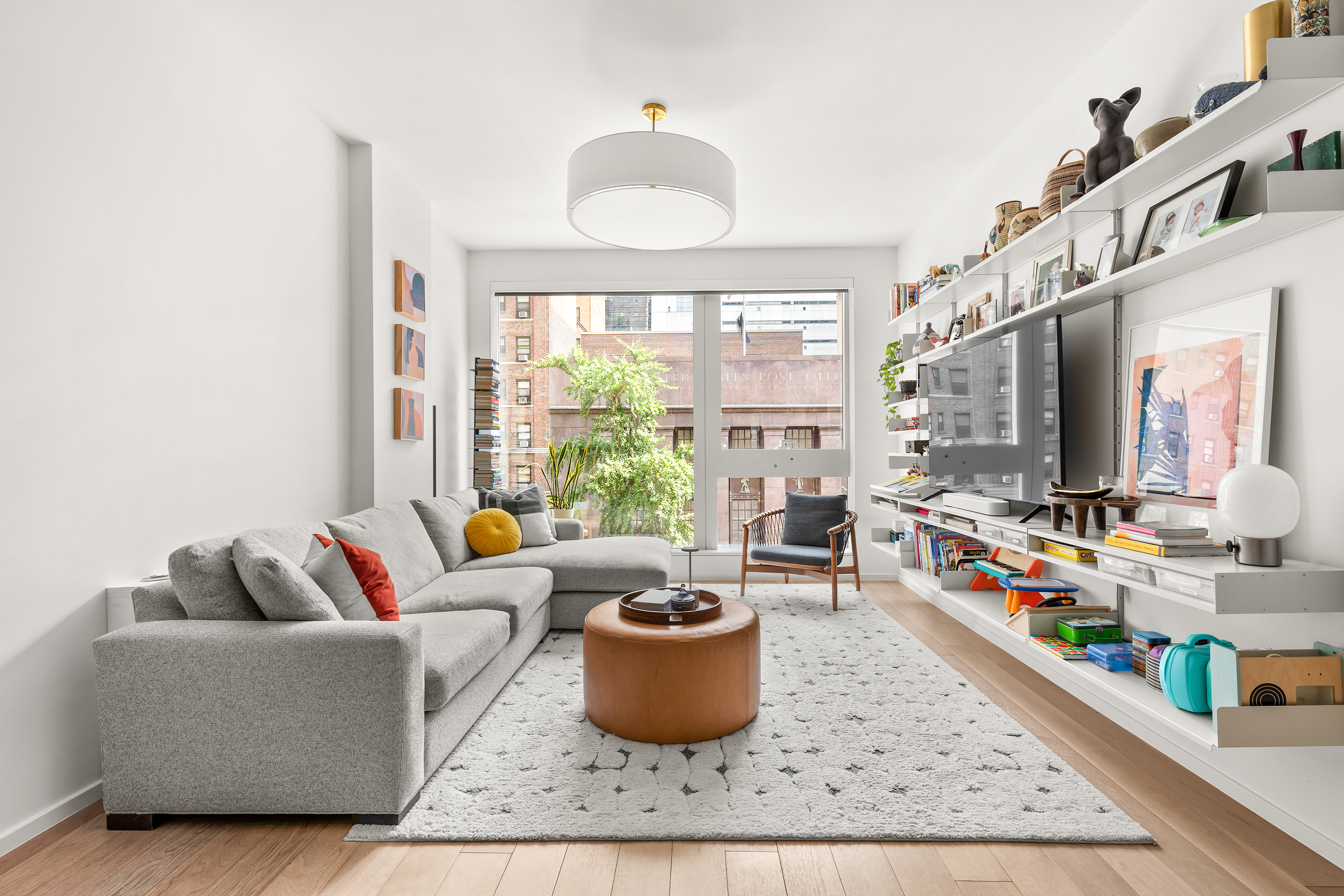 a living room with furniture and a potted plant