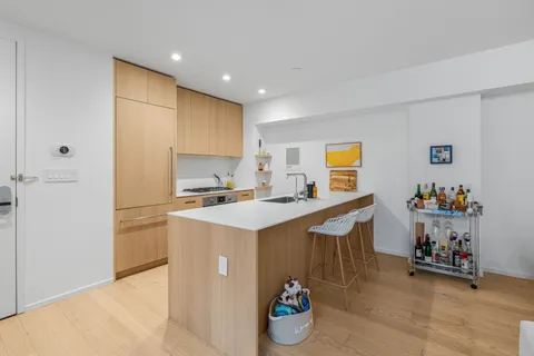 a kitchen with a sink a stove cabinets and a refrigerator