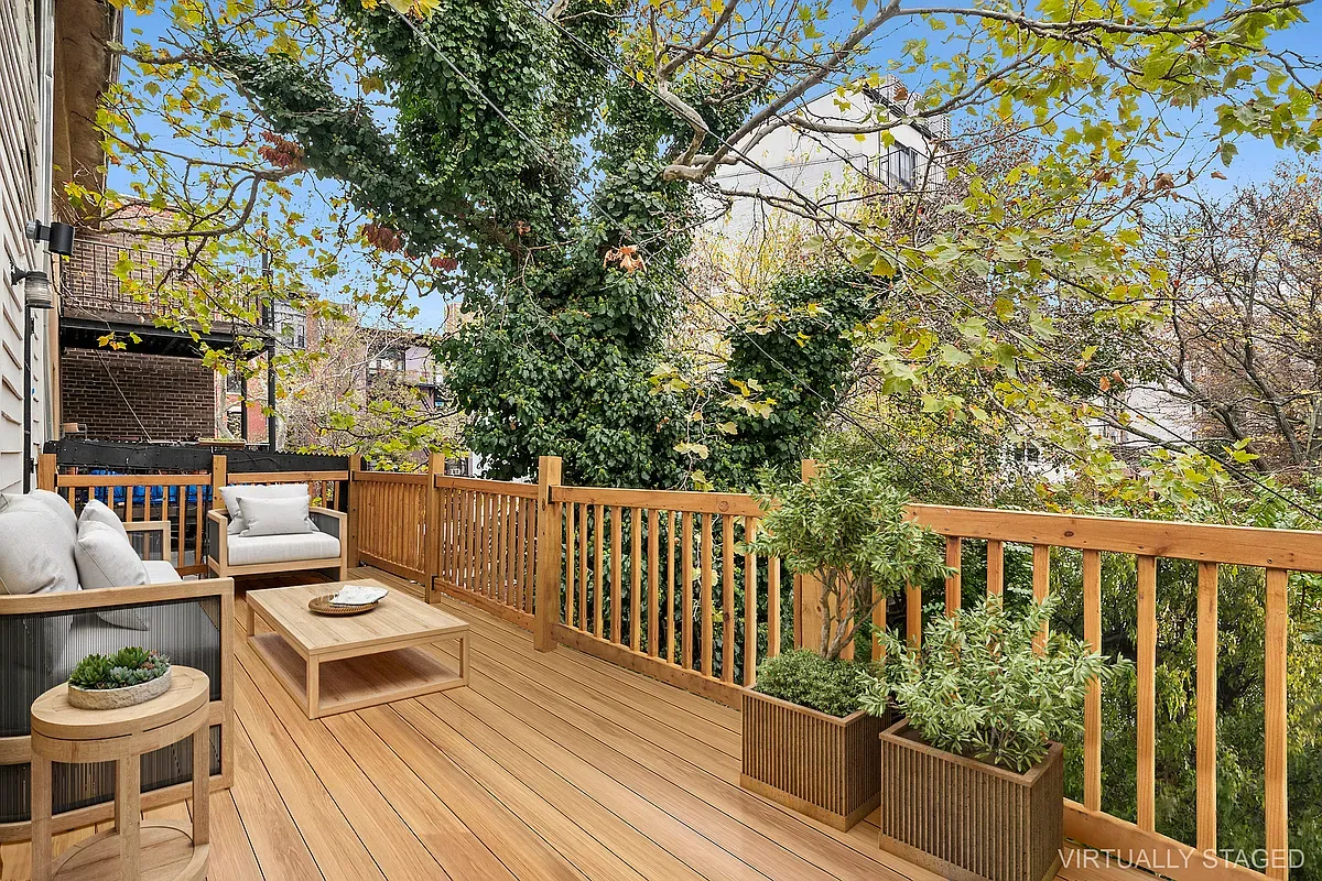 a balcony with wooden floor and outdoor seating