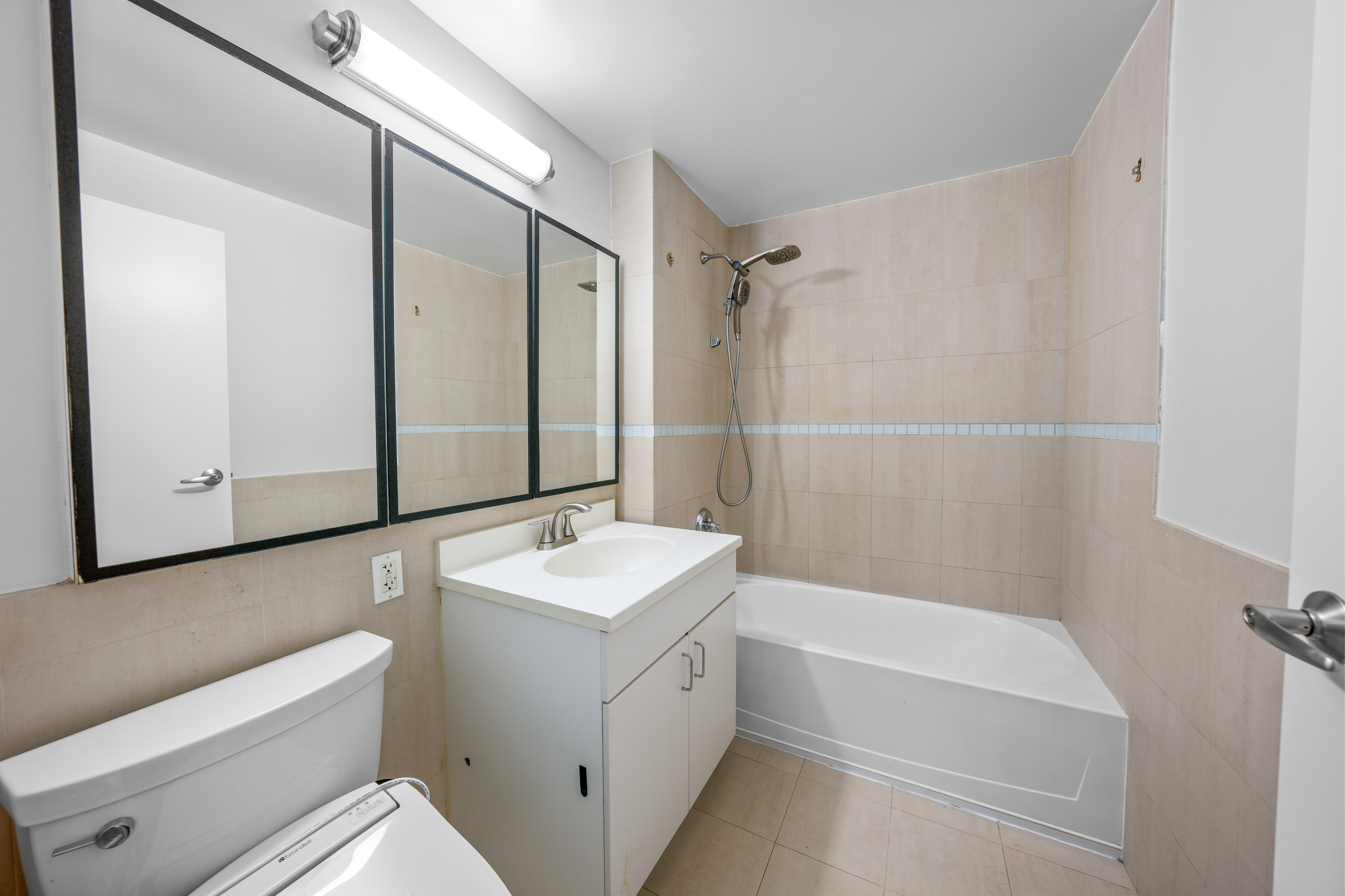 40 West 116th Street, Unit B301 Manhattan, NY 10026 - Photo 9 of 17 a bathroom with a sink a toilet and shower