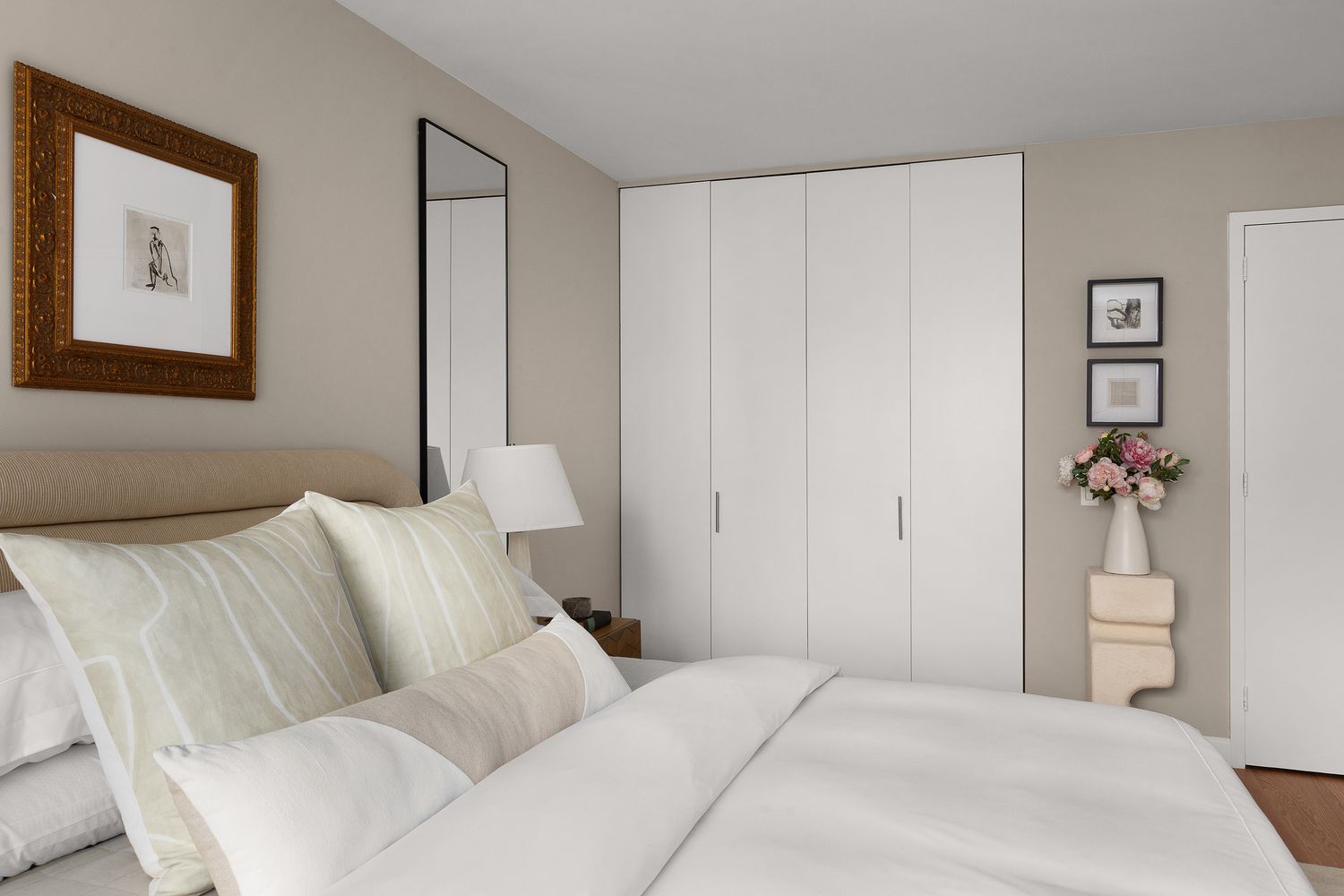 a bedroom with a bed and a painting on the wall