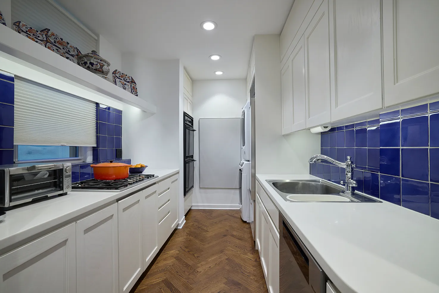 a kitchen that has a sink and a stove in it
