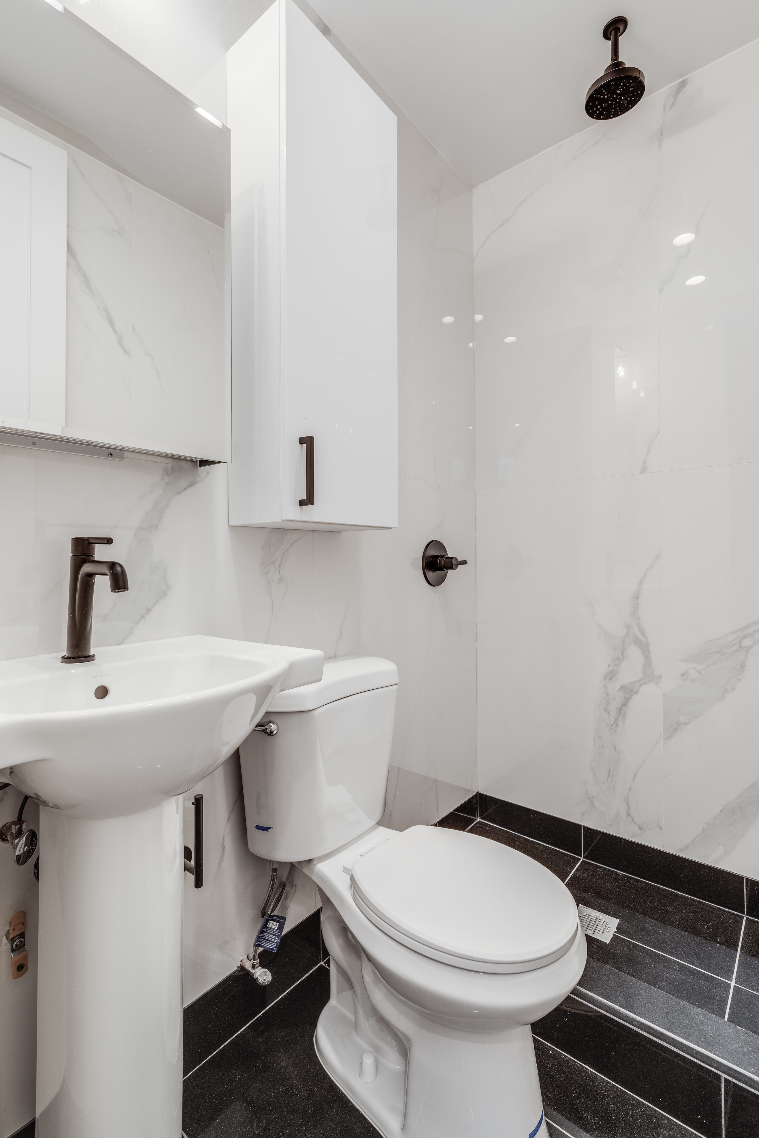 464 West 23rd Street, Unit 1R Manhattan, NY 10011 - Photo 8 of 9 a bathroom with a sink toilet and a mirror