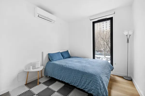 a bedroom with a bed and a window