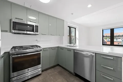 a kitchen with granite countertop a stove and a microwave