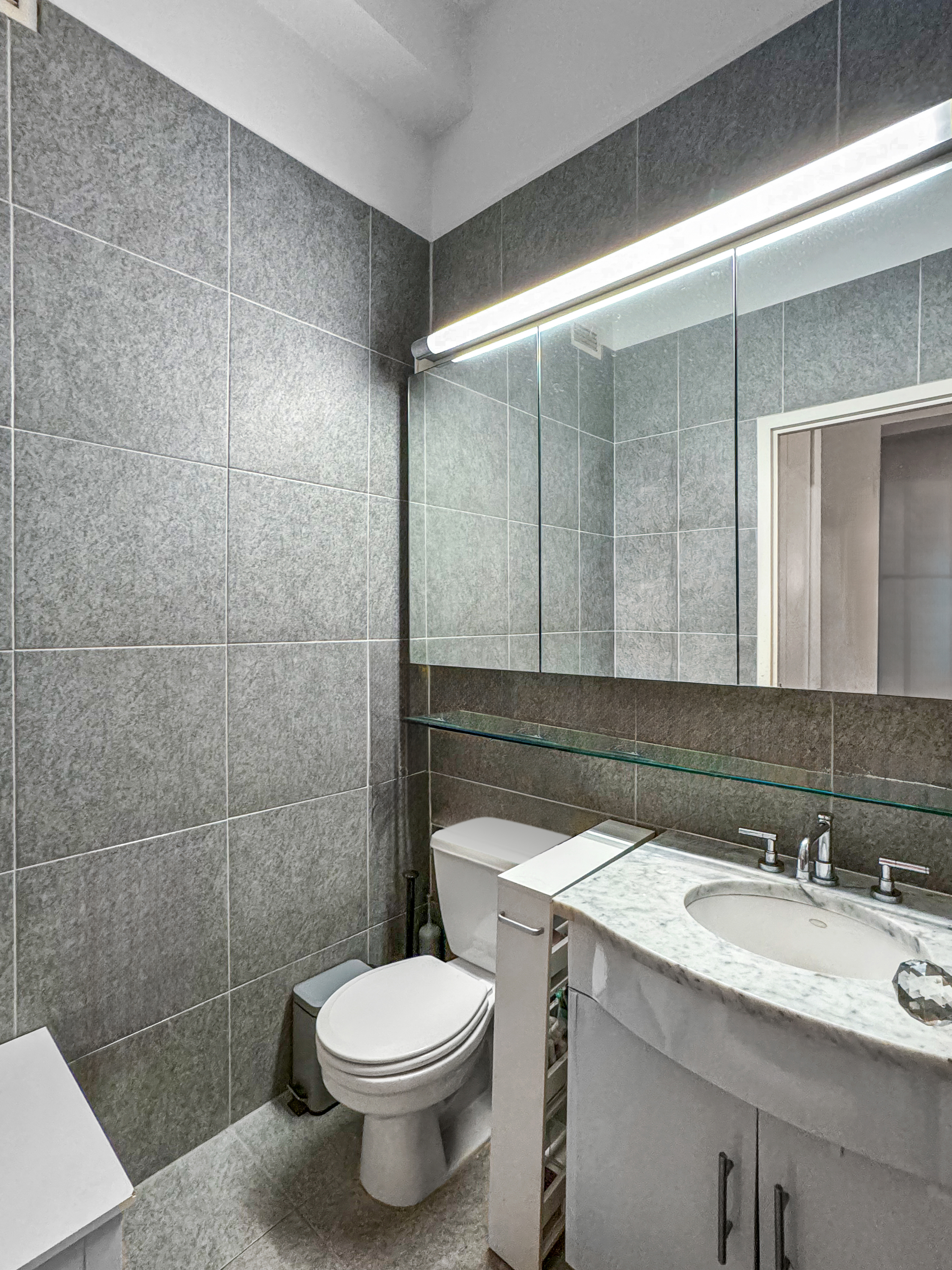 80 John Street, Unit 10D Manhattan, NY 10038 - Photo 5 of 6 a bathroom with a sink a toilet and shower