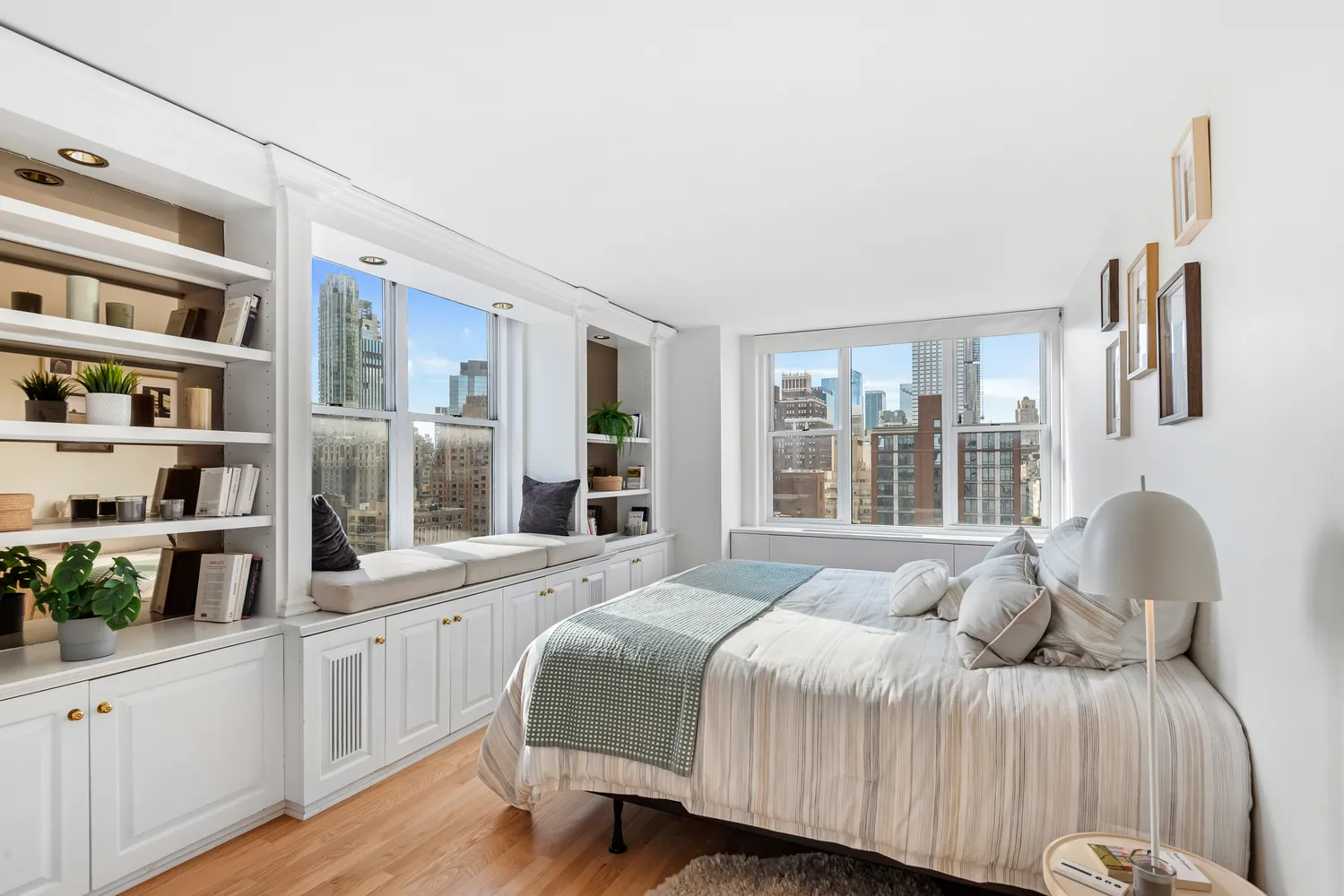 a bedroom with a bed and a large window with the outer view