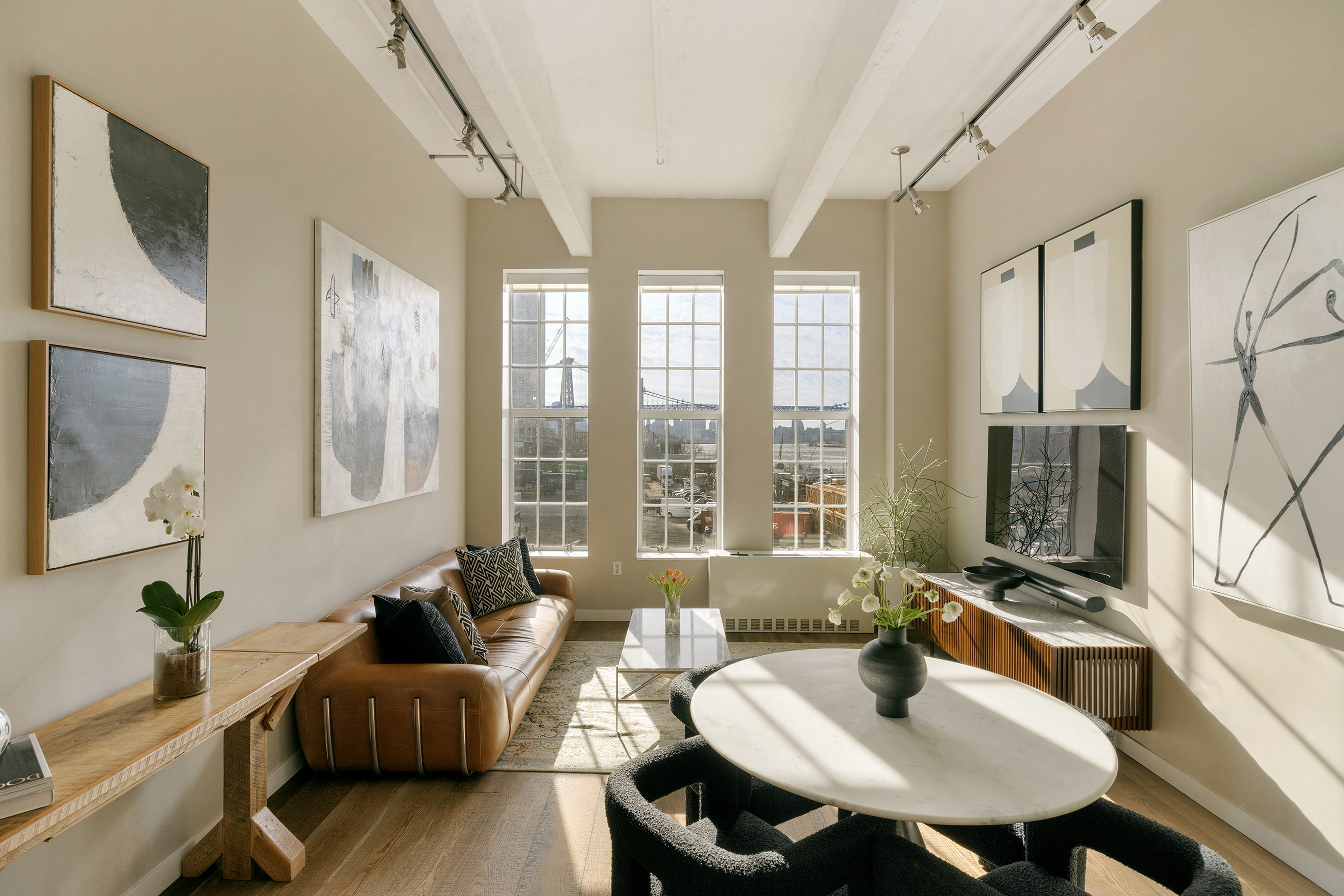 184 Kent Avenue, Unit B305 Brooklyn, NY 11249 - Photo 1 of 15 a living room with furniture and a large window