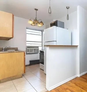 a view of kitchen with cabinets and wooden floor