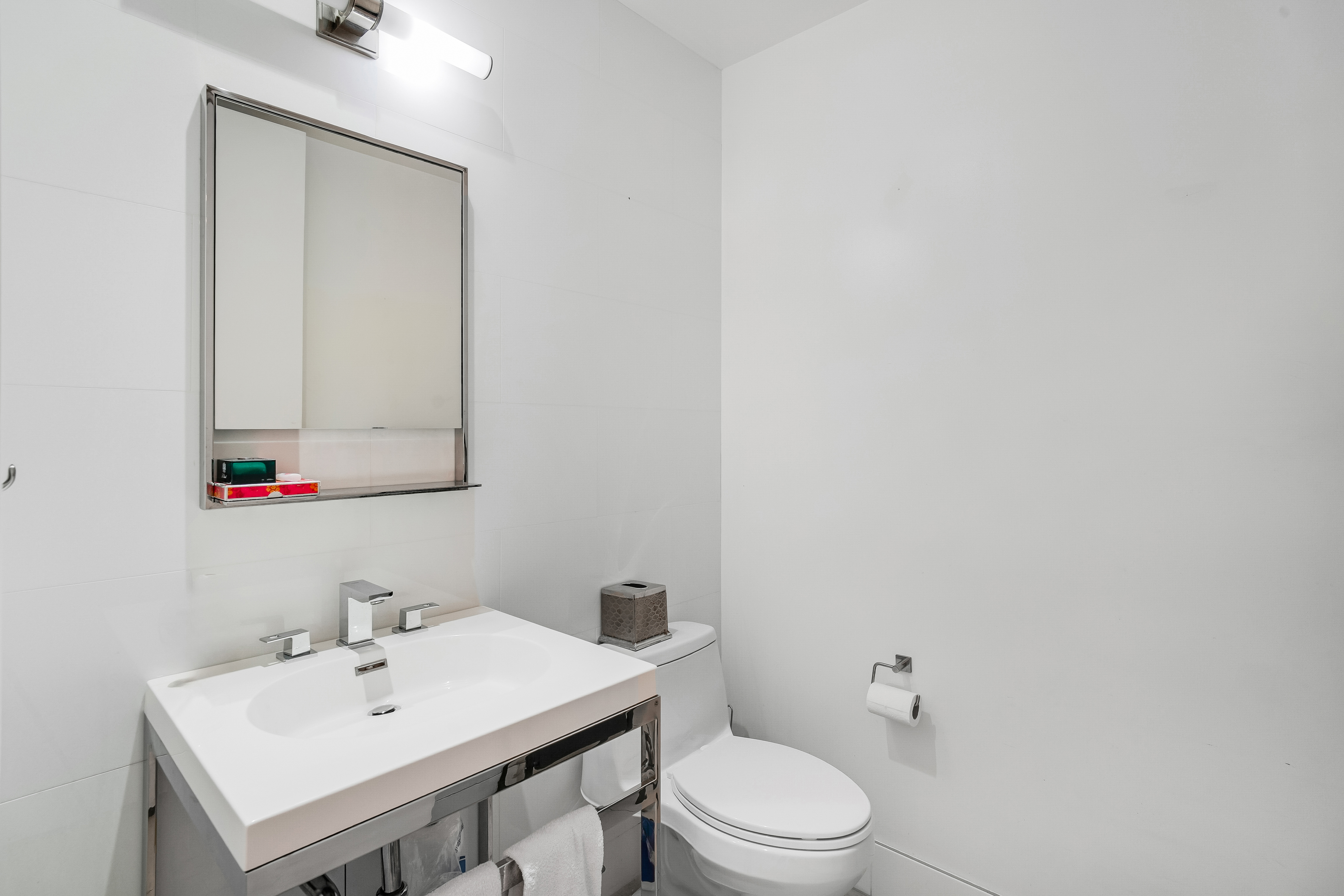 450 East 83rd Street, Unit 6B Manhattan, NY 10028 - Photo 15 of 25 a bathroom with a sink a toilet and mirror