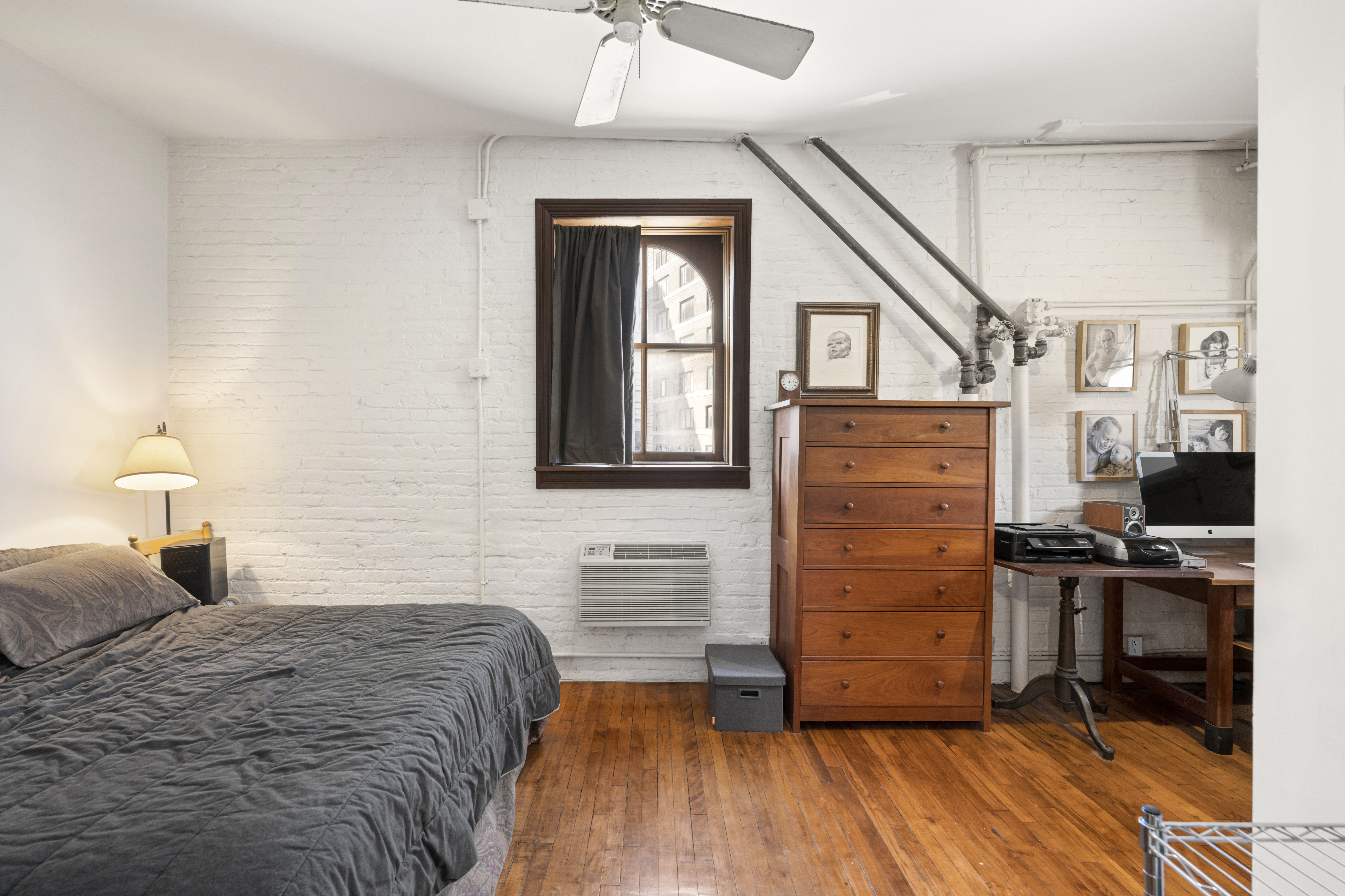 210 Spring Street, Unit 5 Manhattan, NY 10012 - Photo 7 of 10 a bedroom with a bed and a dresser