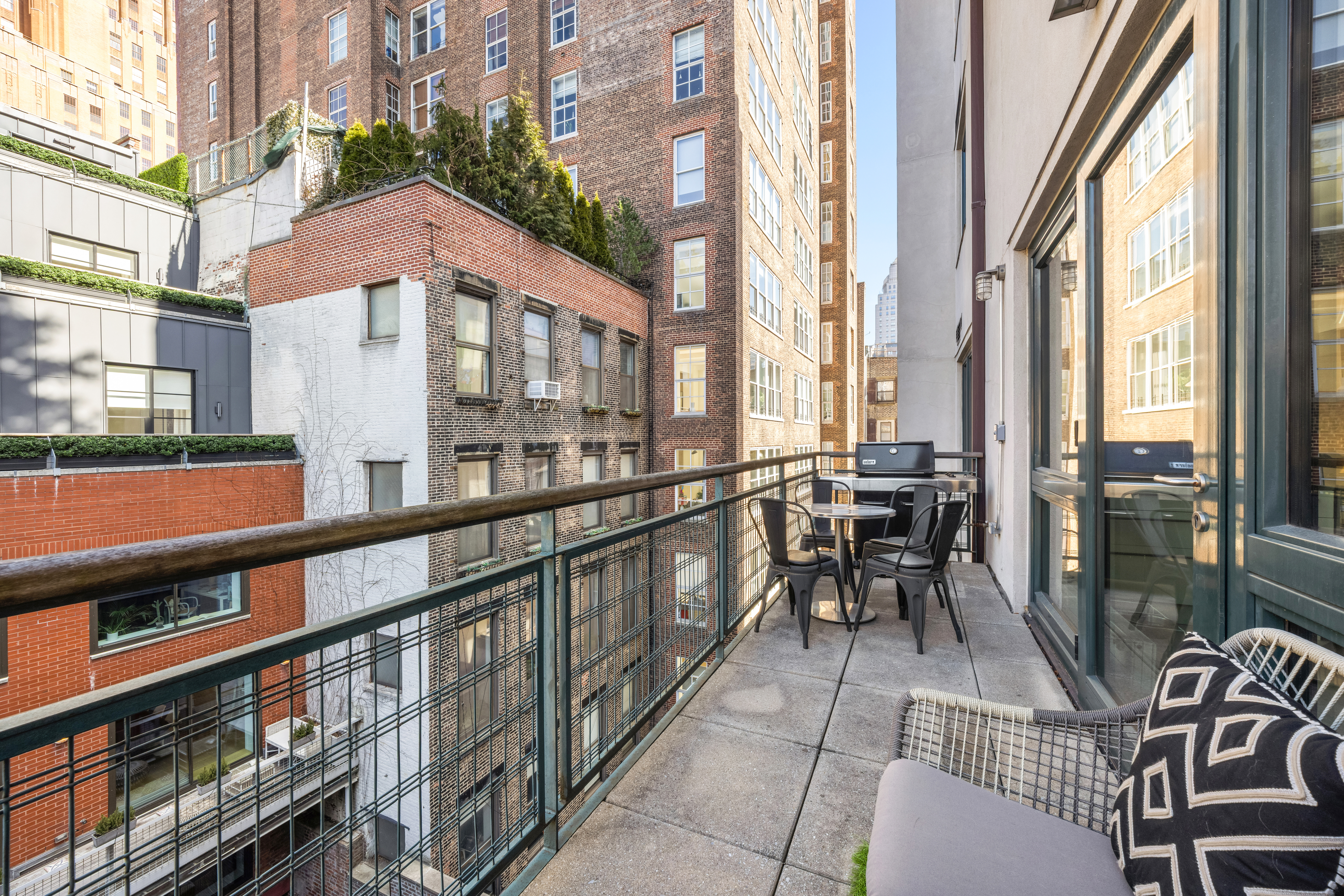 138 Reade Street, Unit 5 Manhattan, NY 10013 - Photo 8 of 23 a city view from a balcony with chairs