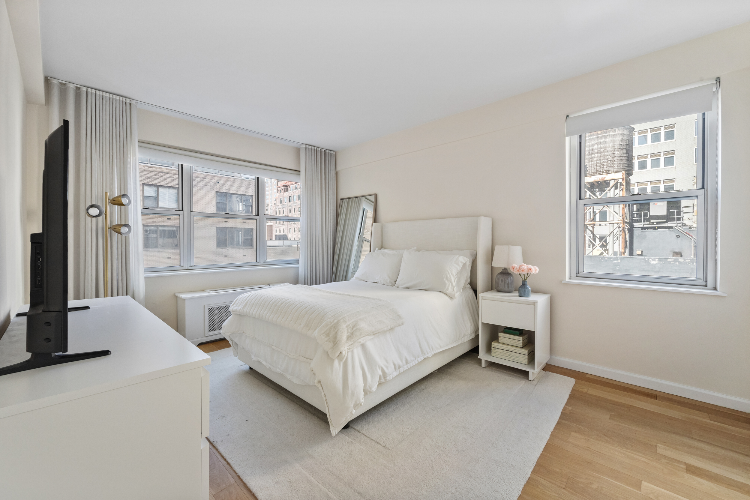 80 Park Avenue, Unit 11D Manhattan, NY 10016 - Photo 4 of 7 a bedroom with a bed lamp and window
