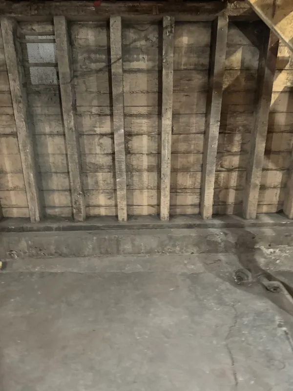 a view of an empty room with wooden walls