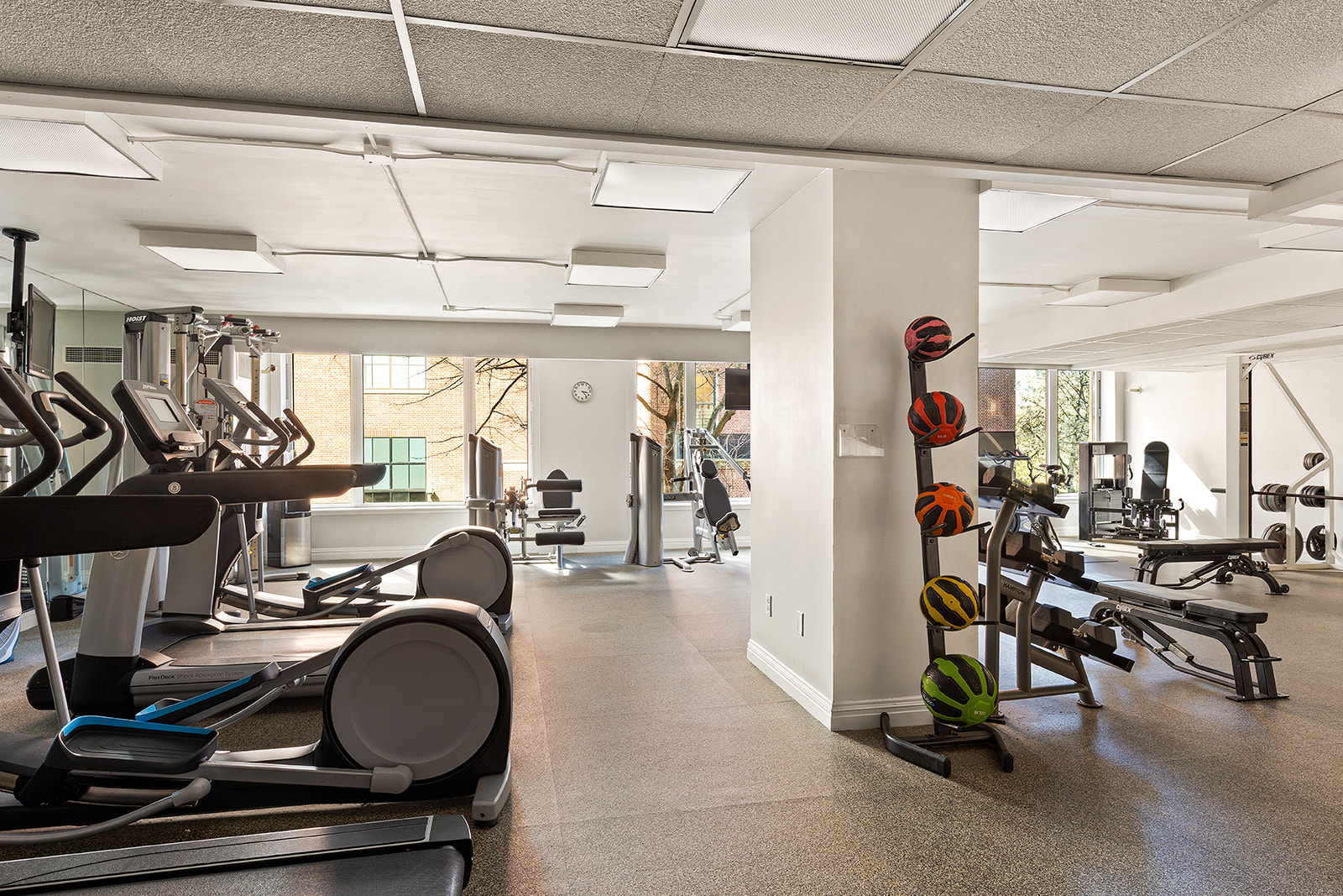 90 East End Avenue, Unit 4B Manhattan, NY 10028 - Photo 10 of 13 a room with gym equipment and large mirror