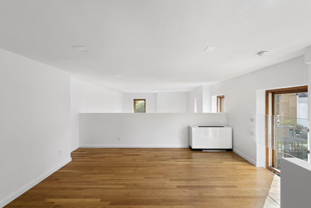 305 2nd Avenue, Unit 505 Manhattan, NY 10003 - Photo 6 of 17 a view of room and window with wooden floor