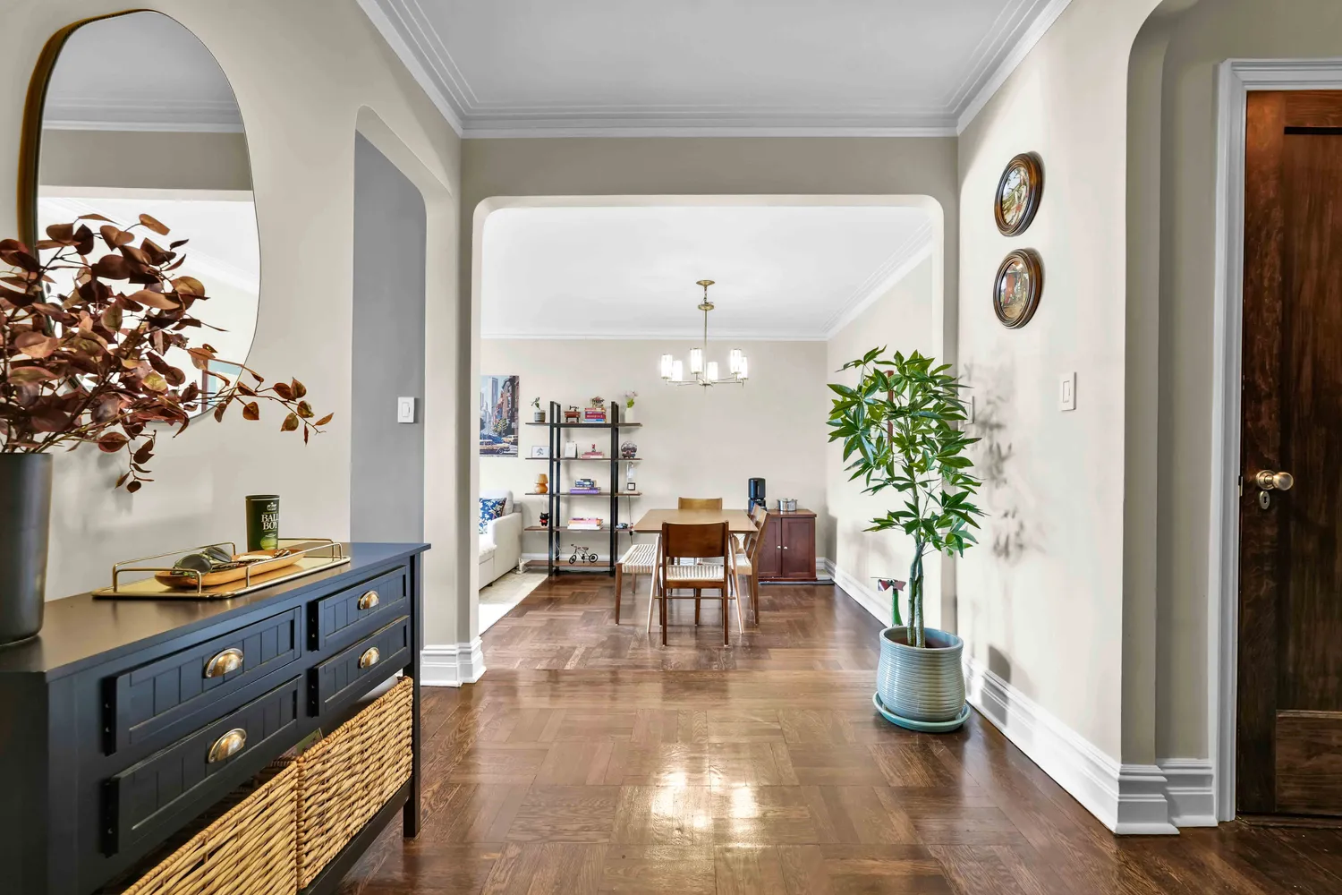 a dining room with furniture and a potted plant