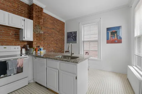 a kitchen with stainless steel appliances granite countertop a sink and a stove