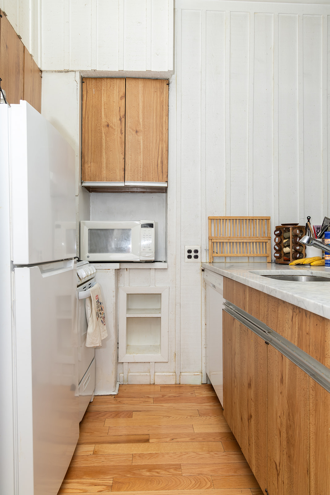 147 Sullivan Street, Unit 2A Manhattan, NY 10012 - Photo 5 of 8 a kitchen with a refrigerator and white cabinets