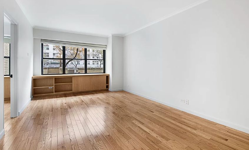 wooden floor in an empty room with a window