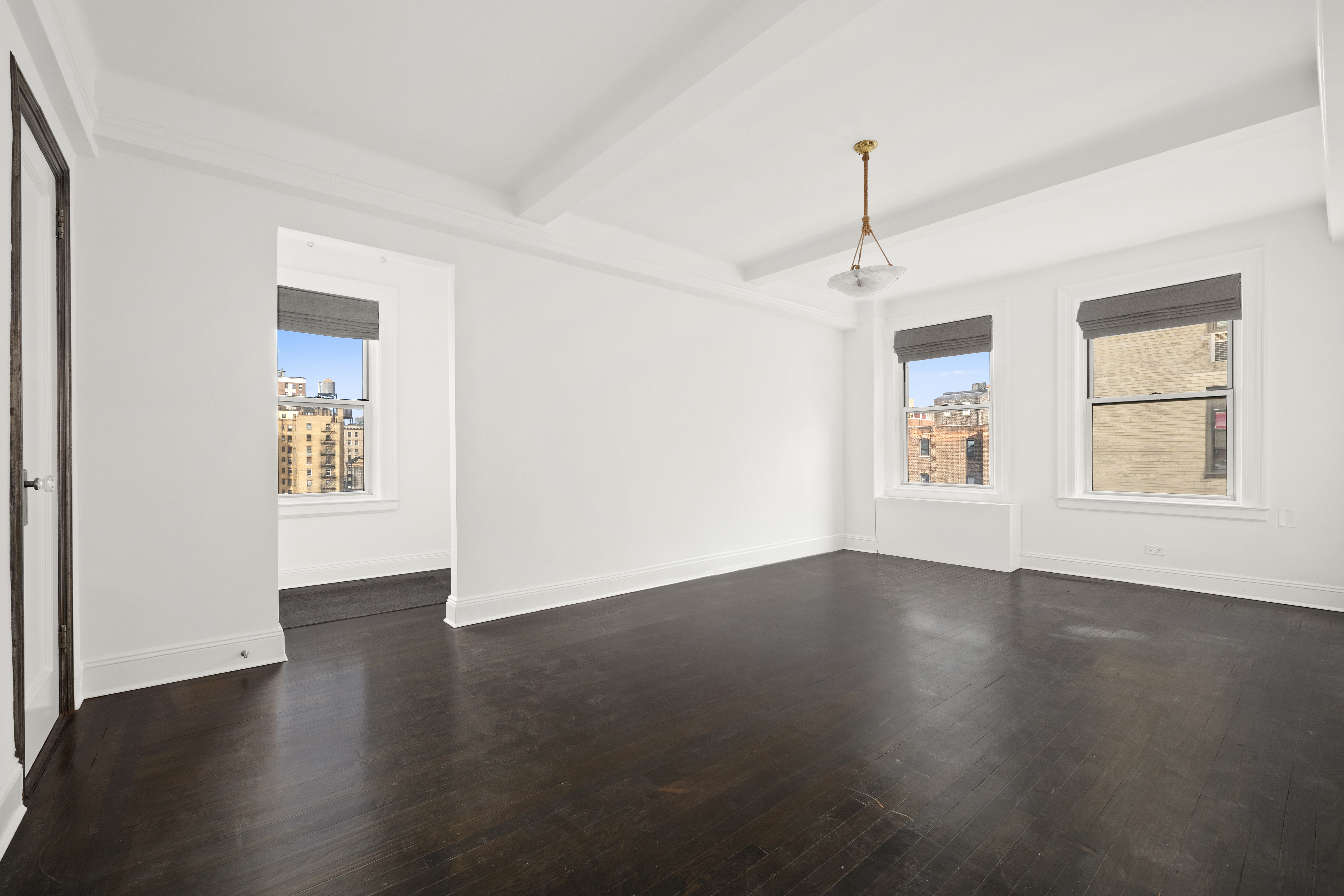 110-118 Riverside Drive, Unit 15C Manhattan, NY 10024 - Photo 6 of 6 a view of an empty room with wooden floor and a window