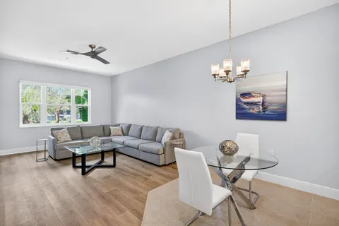 a living room with furniture and a chandelier