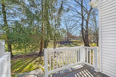 a view of a pathway of a house with wooden fence