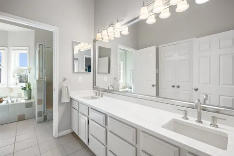 a bathroom with a sink a vanity and a mirror