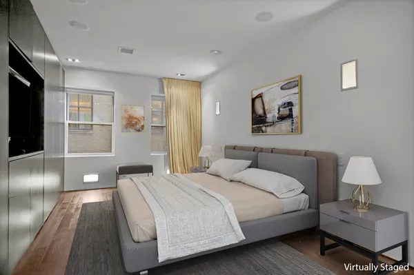 a bedroom with a bed and a lamp on table