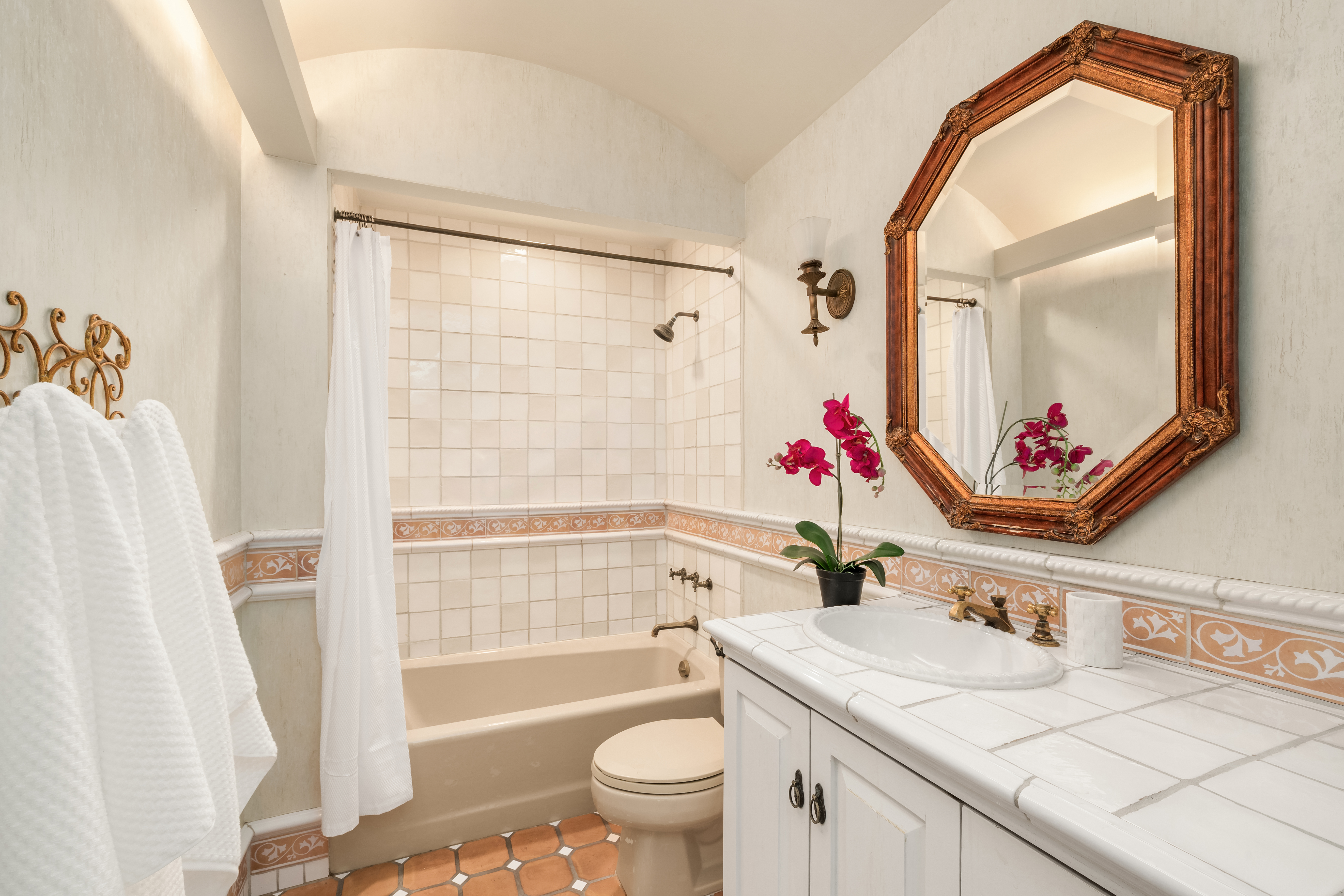 228 West 21st Street, Unit 2 Manhattan, NY 10011 - Photo 7 of 9 a bathroom with a granite countertop sink mirror vanity and toilet